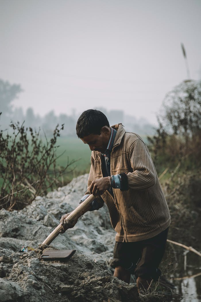 A dedicated farmer working in a rural field in Kanpur, India. An outdoor scene capturing traditional agriculture.